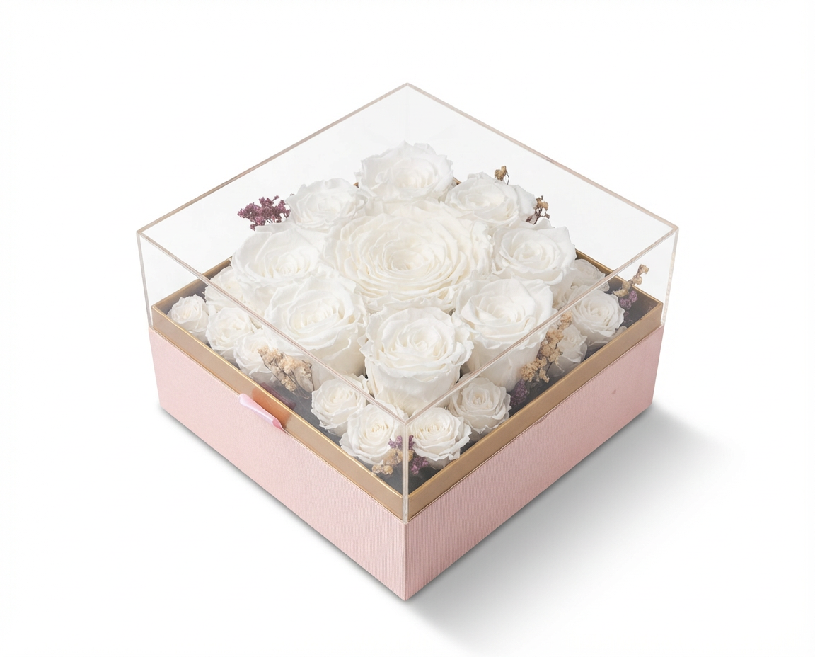 Clear box with preserved white flowers on a light pink base