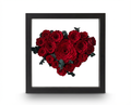 Luxury heart-shaped arrangement of eternal red roses in a black frame on a white background